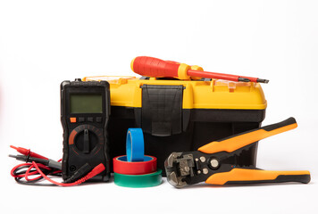 Toolbox isolated on white background.Box with electrician's tools. Multimeter, construction tape, electrical tape, screwdrivers, pliers and an automatic insulation stripper.