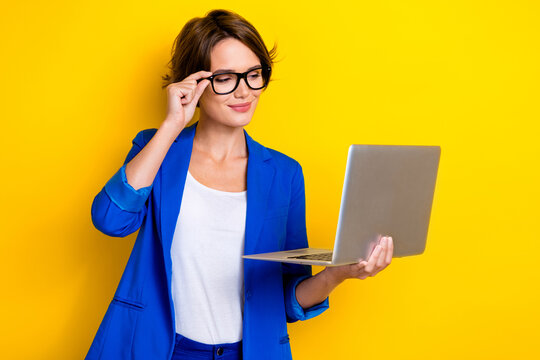 Photo of beautiful young businesswoman bob brown hair wear blue blazer touch spectacles samsung laptop conference isolated on yellow color background