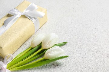 Fototapeta na wymiar Beautiful white tulip flowers and gift box on light background