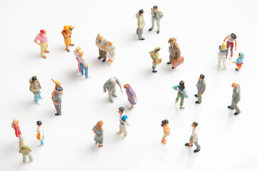 miniature people. different people stand on a white background. communication of society of different generations
