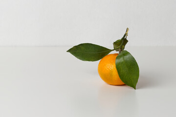 Tangerine with green leaves. White background, horizontal orientation, copy space.