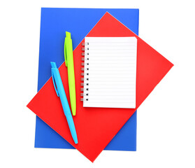 Colorful notebooks with pens on white background