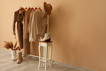 Rack with stylish clothes in interior of dressing room