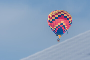 Hot Air Balloon in flight. Hot air ballooning flying in the sky in Switzerland.