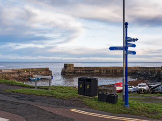 Craster harbour in Northumberland, UK with signpost and copy space