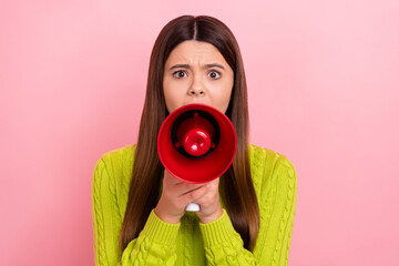 Portrait of unsatisfied girl arms hold loudspeaker share say tell information isolated on pink...