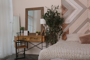 fragment modern wooden bedroom with bed, mirror, wardrobe and chair