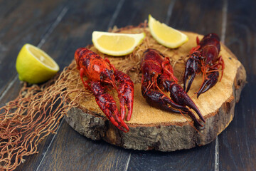 boiled craw fish on kitchen board with net and lemon slices closeup photo © ulianna19970