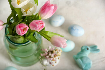 Naklejka na ściany i meble Vase with beautiful tulip flowers, Easter eggs and bunny on light background, closeup
