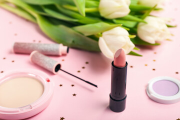 Obraz na płótnie Canvas Beautiful lipstick, cosmetics and tulip flowers on pink background