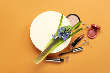Composition with blank card, hyacinth flower and cosmetics on color background
