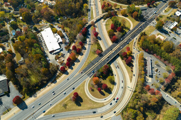 American freeway intersection with fast driving cars and trucks. View from above of USA...