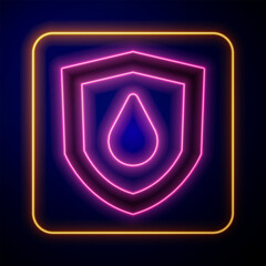 Glowing neon Oil drop on shield icon isolated on black background. Vector