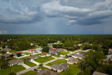 Landscape of dark ominous clouds forming on stormy sky during heavy thunderstorm over rural town...
