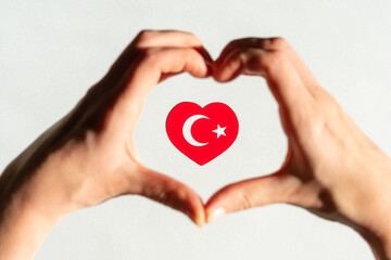 Fototapeta premium Turkish flag in the form of a heart inside a heart from the hands
