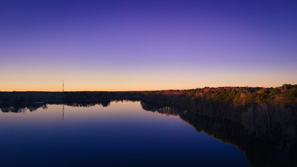 Fototapeta na wymiar beautiful aerial drone view of a lake sunrise at the blue hour of twilight.