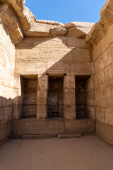 Part of the Luxor Temple, with walls full of hieroglyphics on a sunny day.