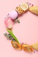 Frame made of flowers, eggs and treats on pink background. Novruz Bayram celebration