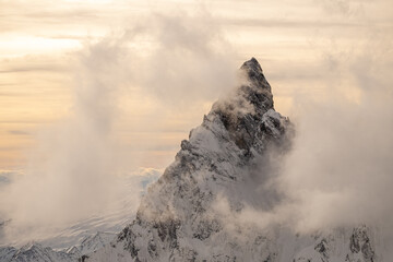 The Matterhorn with snow in the clouds during sunset