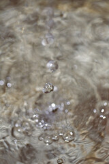 Close up of water droplets and bubbles in a fountain.