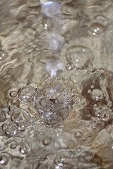 Close up of water droplets and bubbles in a fountain.