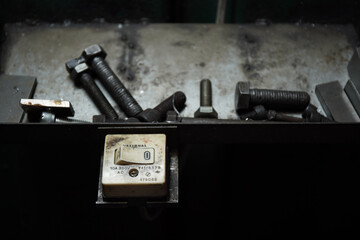 The switch that turns on the lights at the drilling machine
