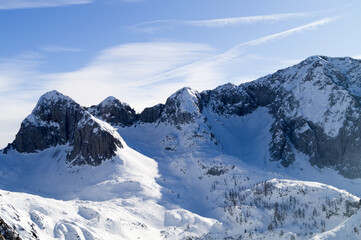 Alps in the background, the towering mountains are covered with fresh white snow against turquoise sky