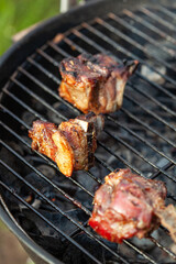 Cooking different meat on barbecue. Grilled and roasted lamb steaks on bbq