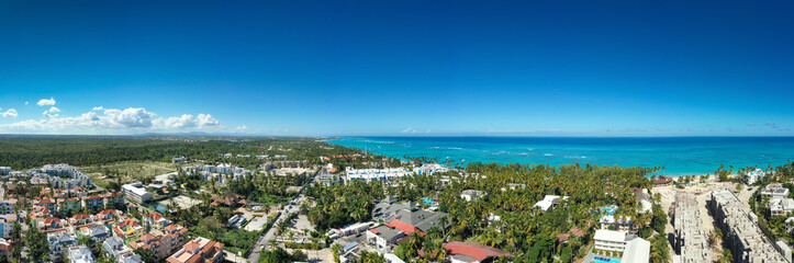 Caribbean beach of Atlantic ocean with luxury resorts, palm trees and turquoise water. travel destination. Aerial panorama view