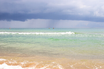Seascape. Blue sea with a wave and dark sky with clouds on a summer day before rain