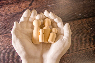 The young man used both of his hands to protect from the falling wooden blocks.