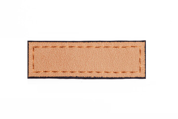 Brown leather belt strap closeup isolated on white. Brown stitched leather seam frame label tag isolated on white. Empty copy space fashion background.