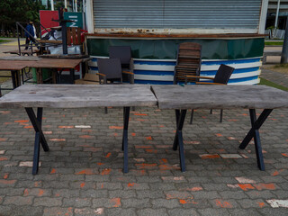 Old wooden tables. Empty tables. There is no trade. Empty place