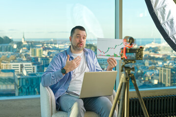 Man making business video blog. Vlogger finance advisor management information. Happy young social media blogger man, making videos for vlog © Ilja