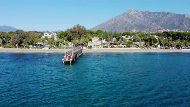 Scenic aerial views of Marbella Club pier, golden mile coastline and La Concha mountain