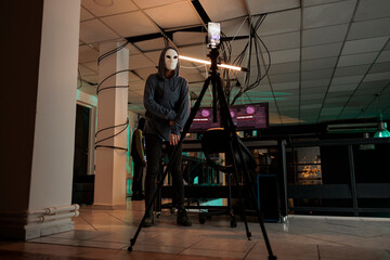 Online fraud, criminal in mask recording video, asking for money, anonymous threatening on phone camera, stealing victim personal information. Cybercrime, internet scam, hacker videocall