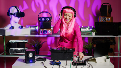 Smiling dj woman dancing and mixing techno sound with electronic remix using professional...