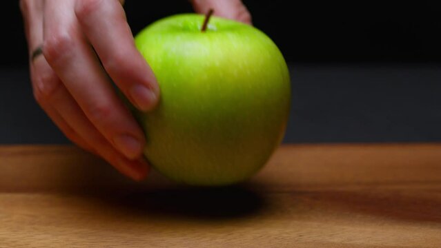 green apple put on the table. slow motion . High quality 4k footage