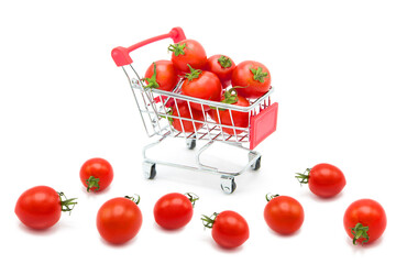 Supermarket shopping cart with ripe fresh tomatoes inside isolated on white background. Organic and environmentally friendly vegetables.