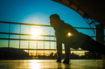 Caucasian male boxer warming up before a fight in the ring outdoors. 