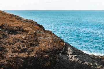 Rocky mountain edge with the ocean in background