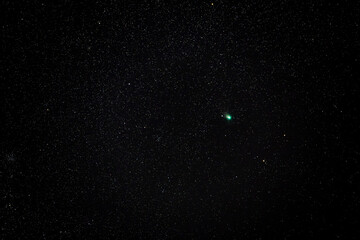 The green comet C/2022 E3 (ZTF) in the constellation Auriga tracked 25 seconds at ISO 2500 in the cold winter night sky with 200mm f2.8 lens, near Darmstadt on February 7th 2023, Germany - obrazy, fototapety, plakaty