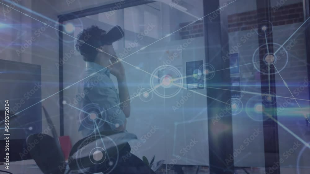 Poster Animation of network of connections over caucasian man wearing vr headset at office