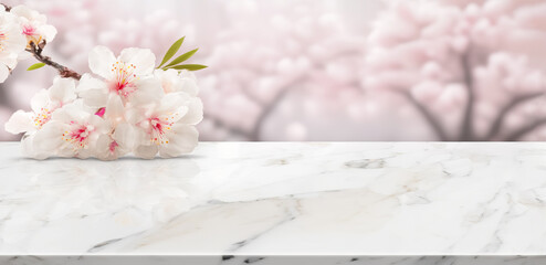  White marble stone table top with Sakura cherry blossoms on blur bokeh background. For display or montage you products. Blank space for beauty product display