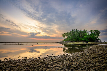 Reflection of the sky and small island in sunset time,  Phuket, Thailand.