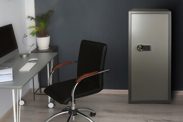 Big steel safe with electronic lock near workplace indoors - obrazy, fototapety, plakaty