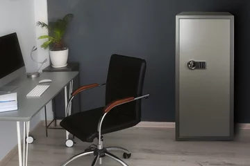 Foto op Canvas Big steel safe with electronic lock near workplace indoors © New Africa