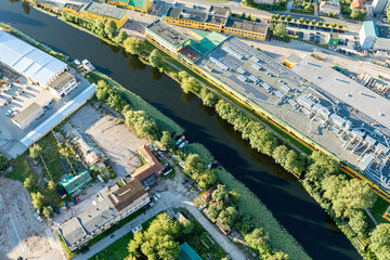 View of the city from a hot air balloon, the river and the industrial area next to it.