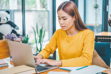 young student wearing headphones studies online, distance learning, and keeps up to date on the global coronavirus pandemic.