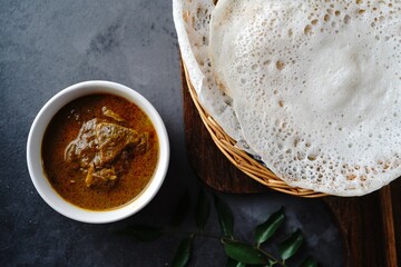 Kerala breakfast appam or palappam with mutton curry
